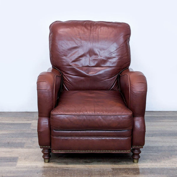 1. Motioncraft lounge recliner in genuine brown leather, decorative nailhead trim, and turned wood feet with brass caps.