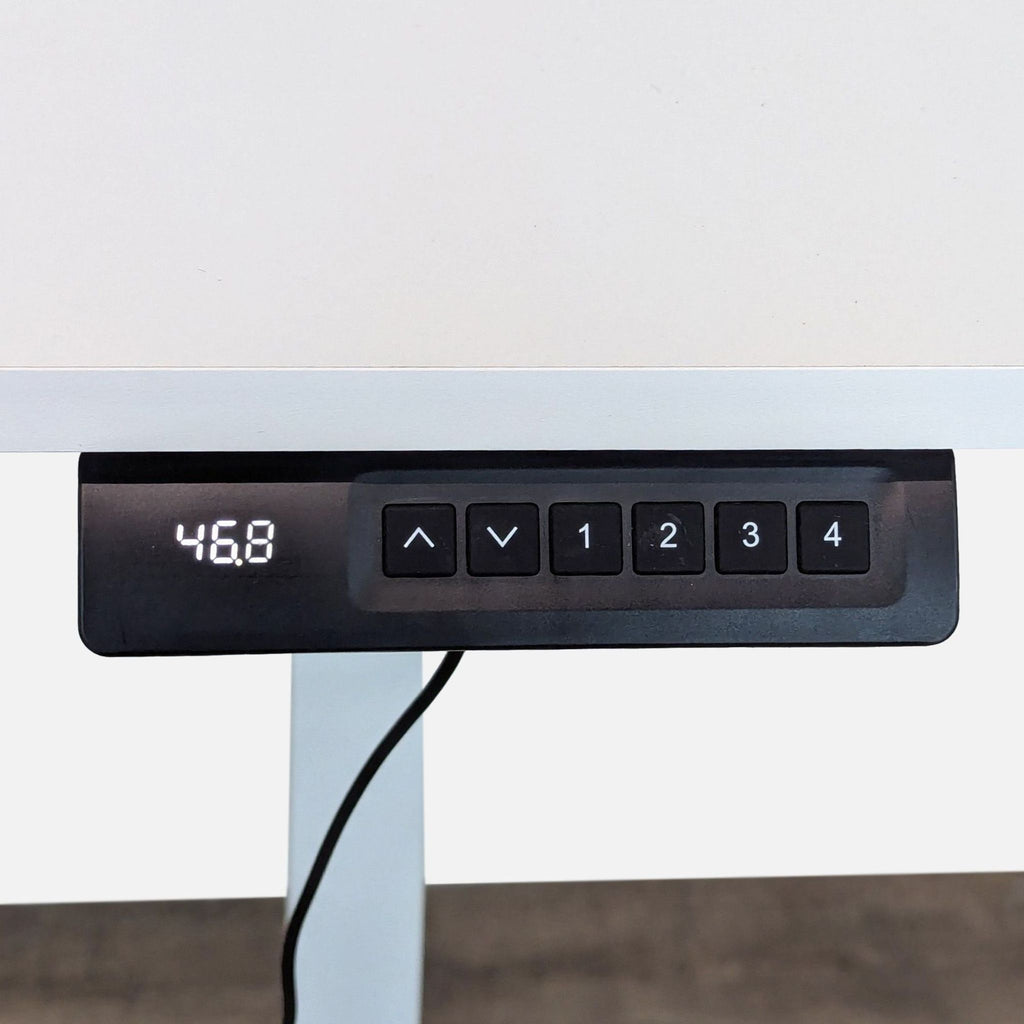 Close-up of Bestqi Innovation desk’s programmable controller with digital height display and memory settings.