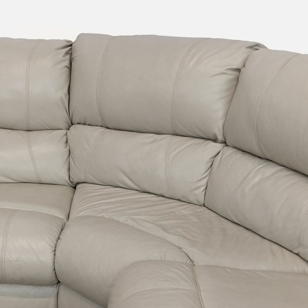 3. Close-up view of Ashley sectional’s leather upholstery, highlighting the soft cushions and detailed stitching.