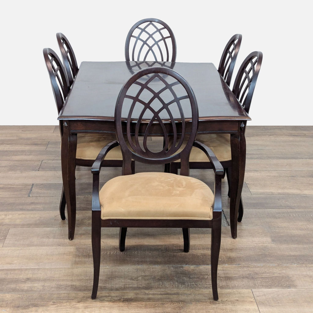 3. Dining set by The Bombay Company featuring upholstered chairs and a mahogany extendable table.