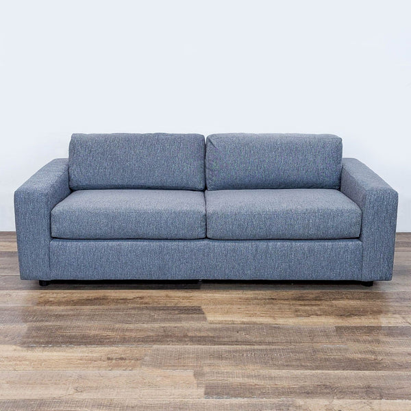 1. Front view of a West Elm sleeper sofa with track arms and a modern blue upholstered design.  