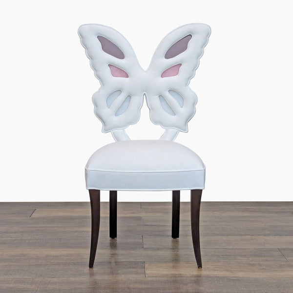 Front view of Haute House dining chair with a butterfly wing back, velvet upholstery, and stained-glass insets.  