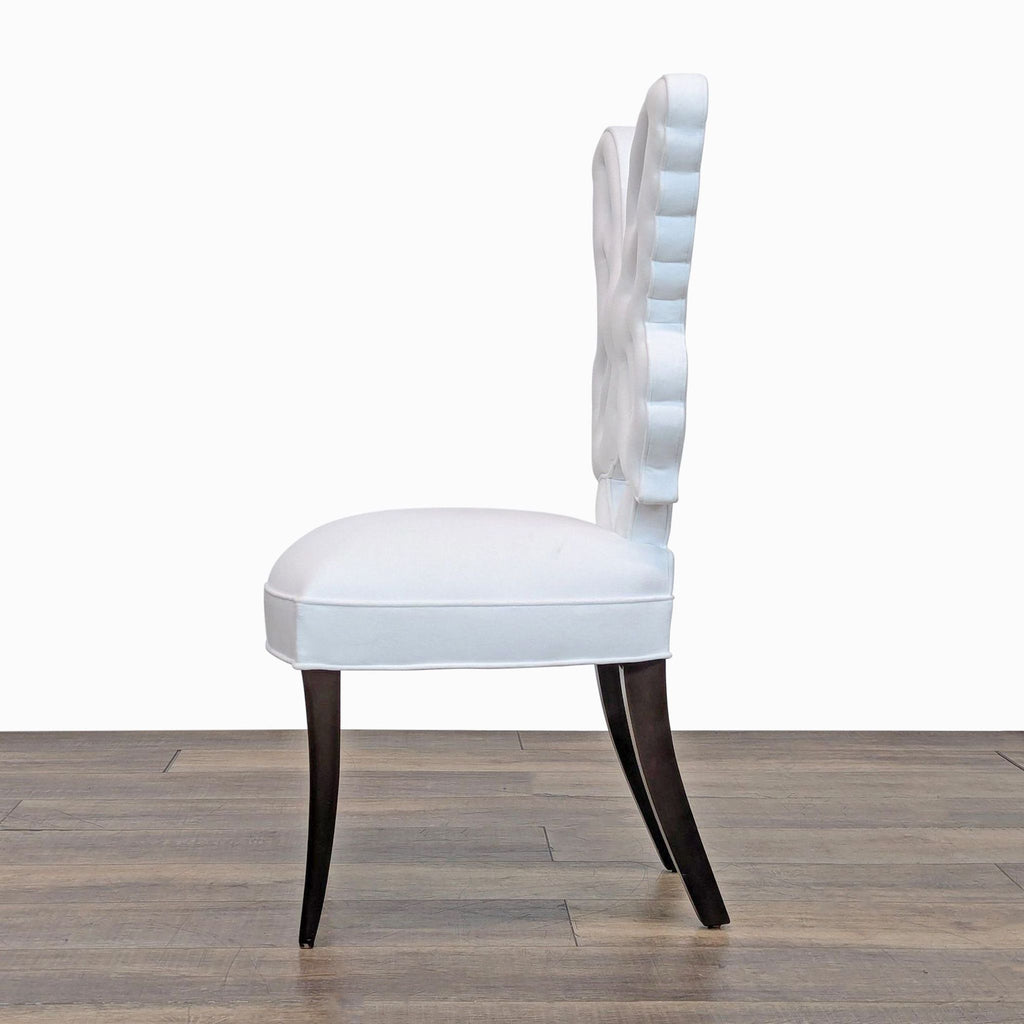 Side profile of handcrafted Haute House dining chair showing the curved back and Bella White velvet seat.  
