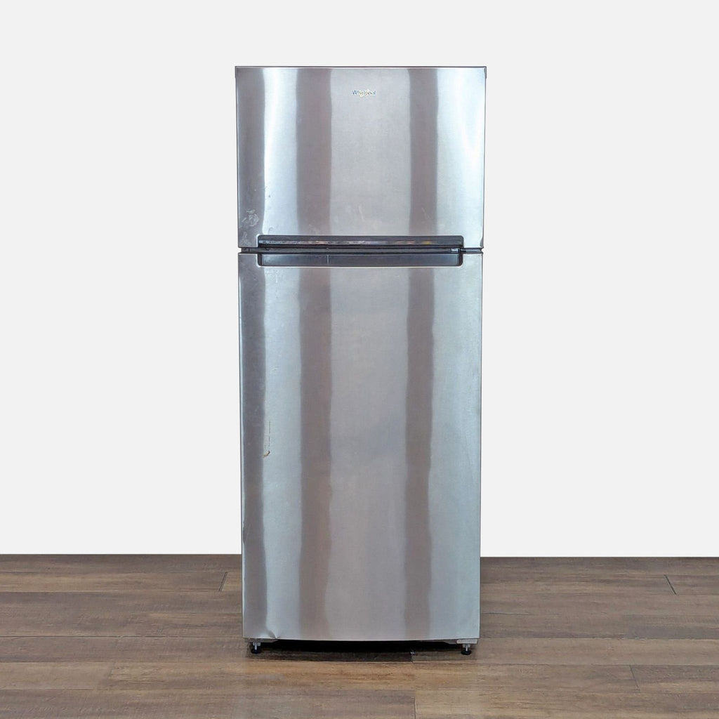 1. Front view of Whirlpool stainless steel top freezer refrigerator featuring a sleek, modern design on wood floor.