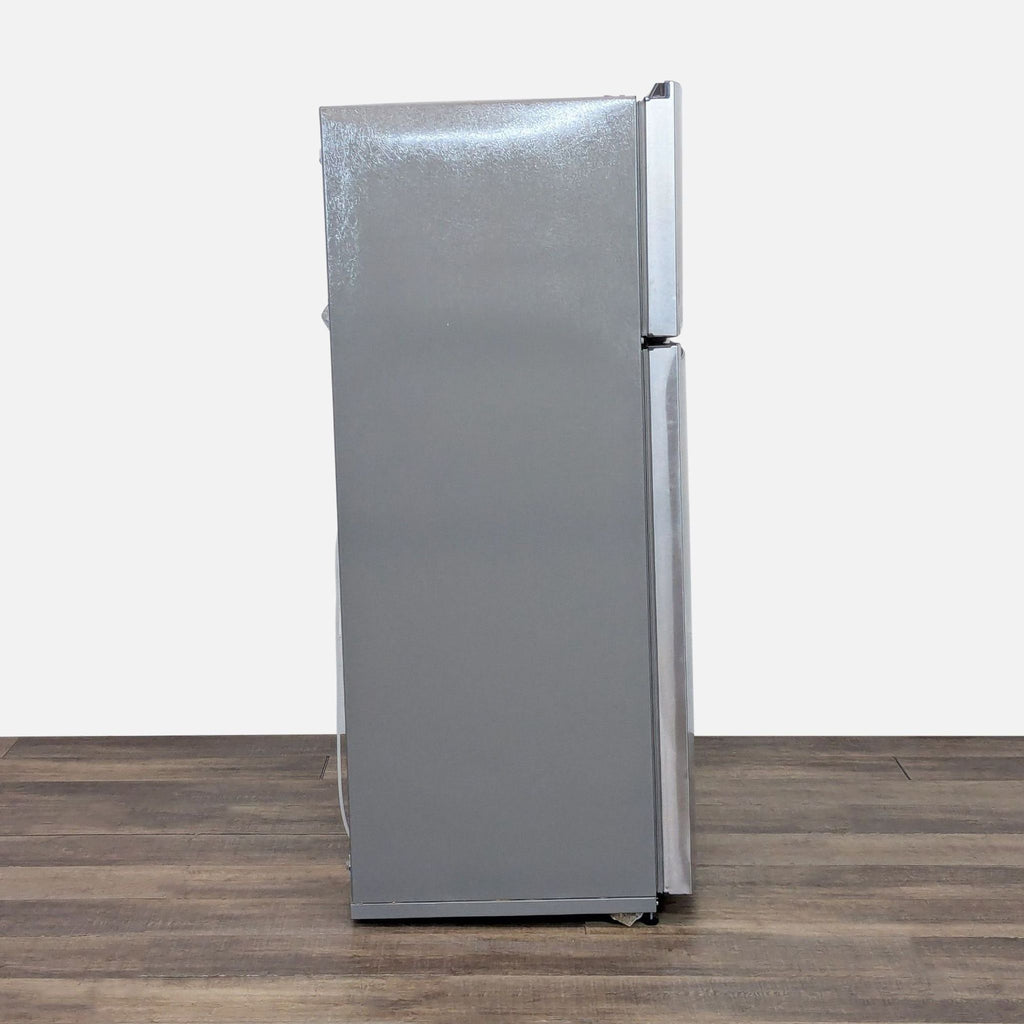 3. Side view of Whirlpool top freezer refrigerator showing clean lines and a smooth stainless steel exterior.