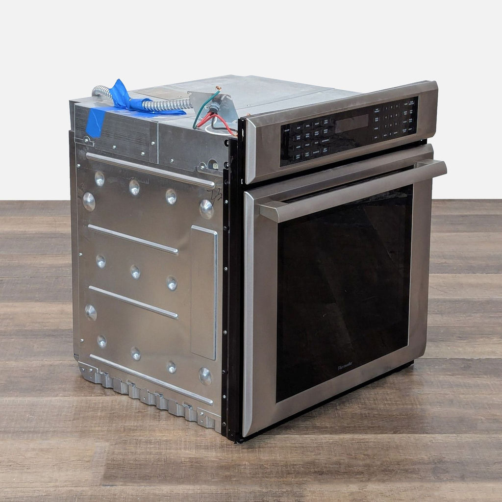 3. Angled side view of the Thermador ME271ES built-in stainless microwave, highlighting modern design and controls.