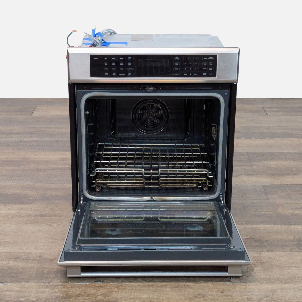 2. Thermador ME271ES microwave oven open, showing spacious stainless interior and wire racks, door lowered.
