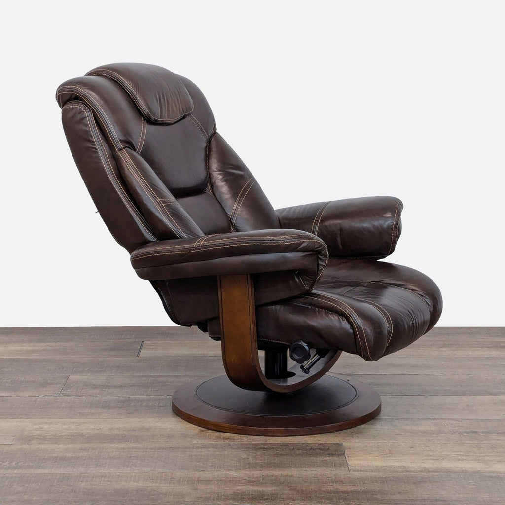 3. Angled side shot of a leather Macy’s lounge chair with plush padding and sturdy walnut base.