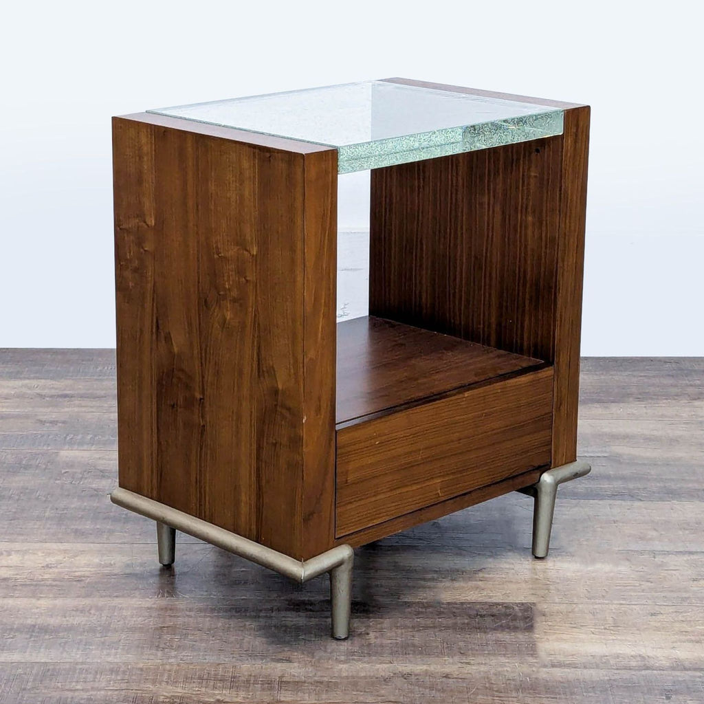 3. Modern Caracole end table with a deep wood finish, lit acrylic top, and spacious drawer with round metal pull.