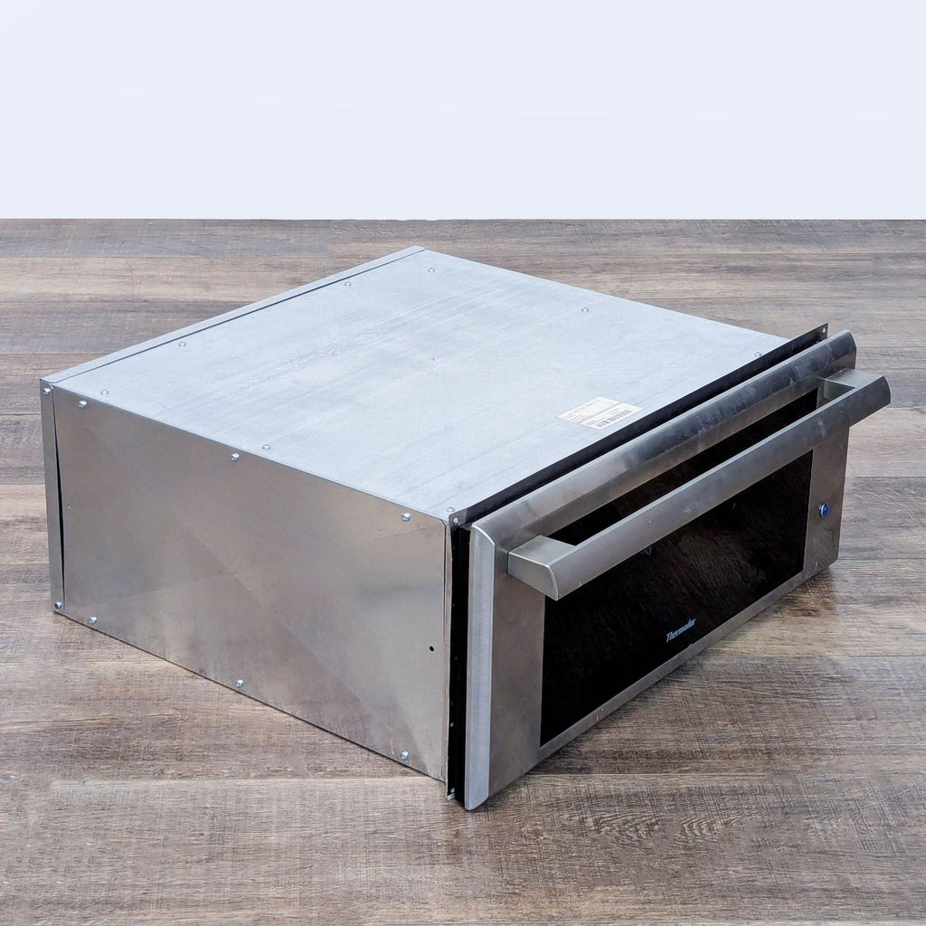 3. Angled side view of the Thermador stainless steel warming drawer, highlighting its modern, durable construction.