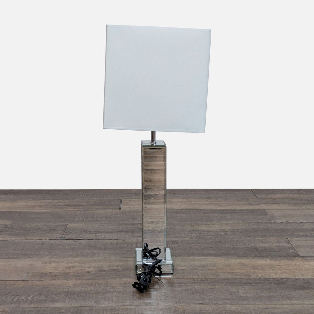 3. Rear view of Reperch table lamp, featuring a mirrored rectangular base and white shade, cord visible.