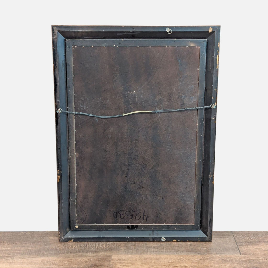 2. The back of a Reperch mirror, revealing a wired hanging system and a dark, worn backing.