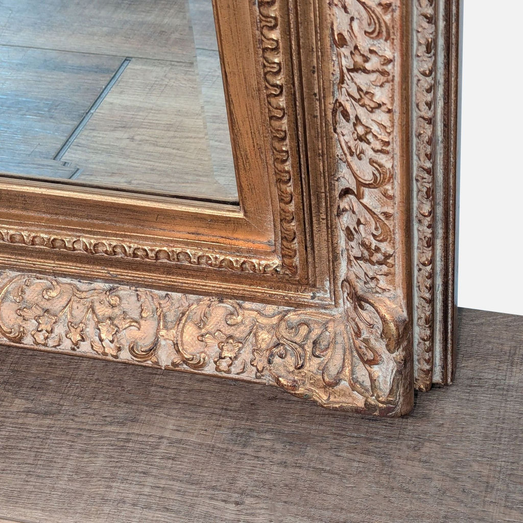 3. Close-up of the Tobi Designs mirror corner, highlighting intricate gold floral and scrollwork detailing on the frame.
