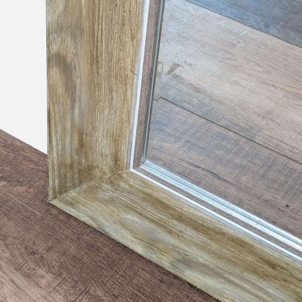 3. Close-up of the Reperch mirror’s corner, highlighting the wood frame texture and mitered edge detail.
