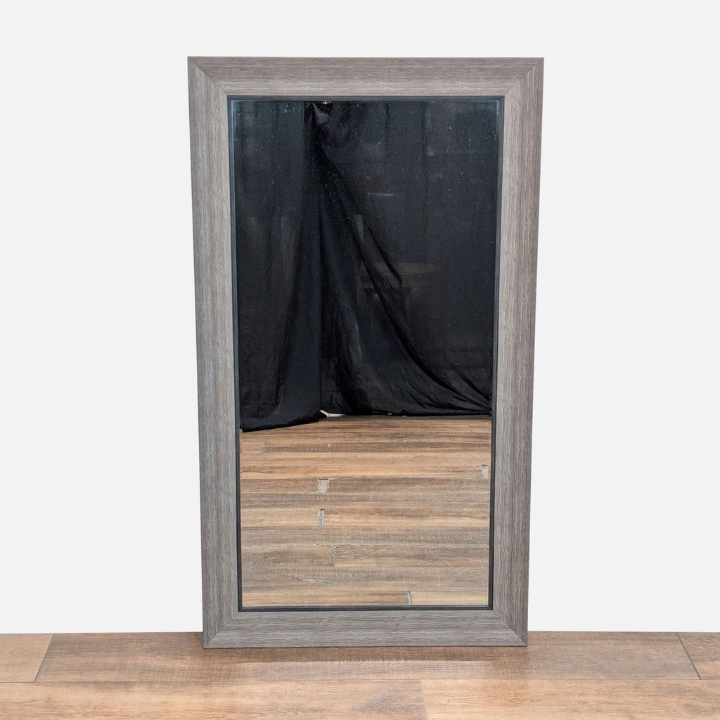 1. Rectangular Reperch mirror with a rustic wood frame, standing on a wooden floor with a black backdrop.  