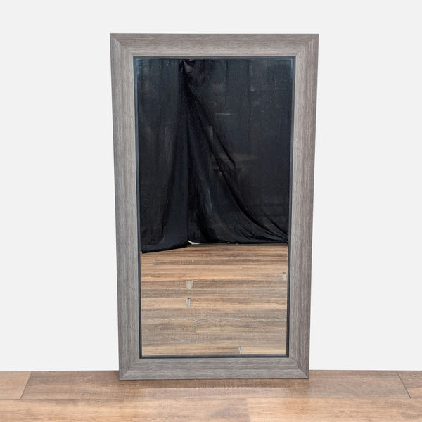 1. Rectangular Reperch mirror with a rustic wood frame, standing on a wooden floor with a black backdrop.  