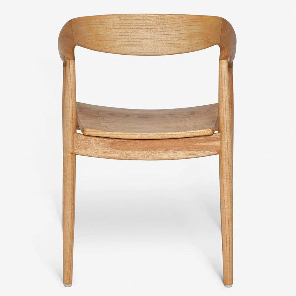 2. Close front view of a mid-century Lulu and Georgia dining chair, featuring a smooth, curved mindi wood frame.  