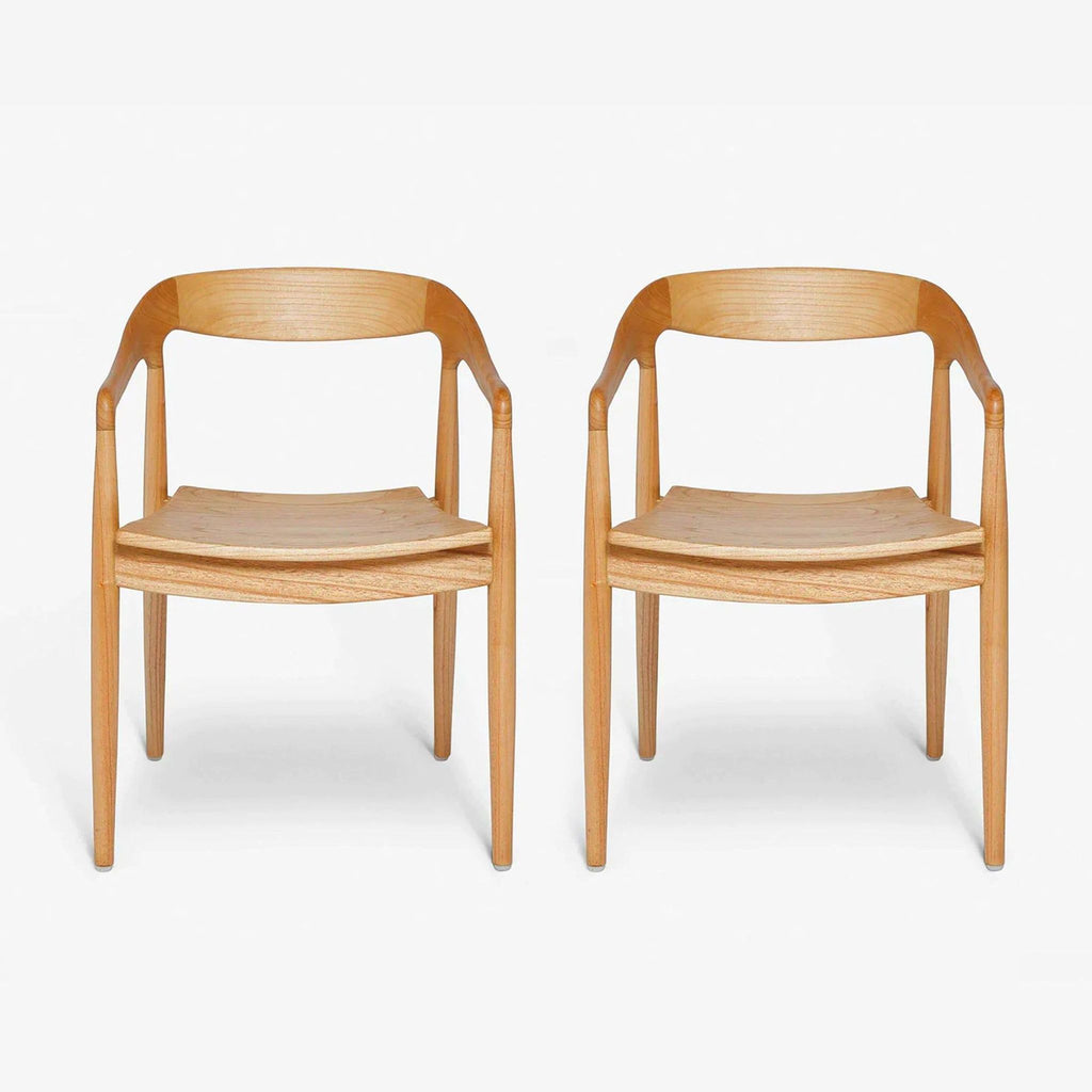 1. Pair of mid-century dining chairs by Lulu and Georgia, crafted from mindi wood with a curved, streamlined design.  