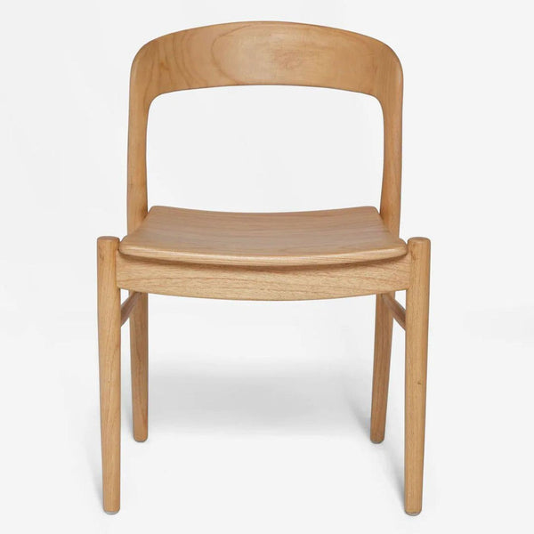 Front view of a mid-century dining chair by Lulu and Georgia, featuring natural mindi wood and curved lines.  