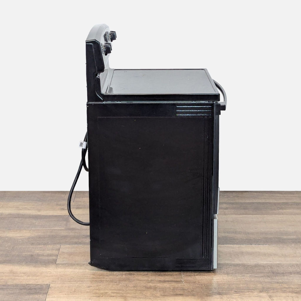 3. Side profile of the Amana electric stove and oven highlighting its sleek black and stainless steel design.