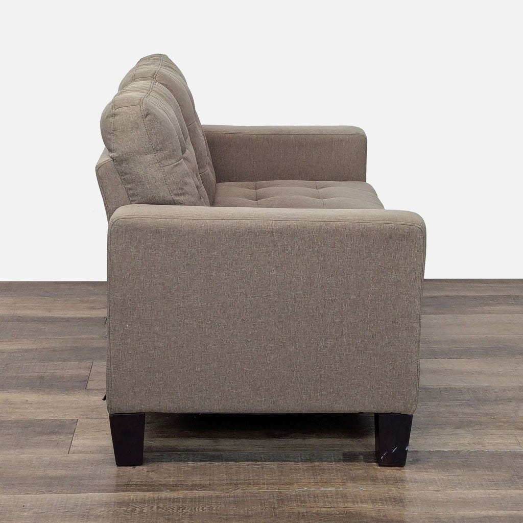 2. Side angle of taupe Amazon loveseat, showing armrest, tufted cushions, and tapered wood feet.