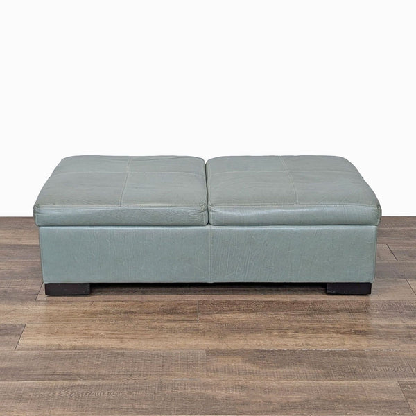 1. Reperch ottoman bench in soft green leather, closed, with a modern rectangular design on wood floor.