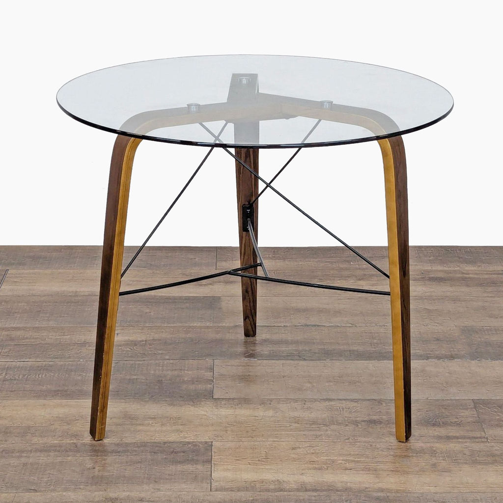 1. Sapphtopaz industrial round dining table with metal base and tempered glass top, on wooden floor.