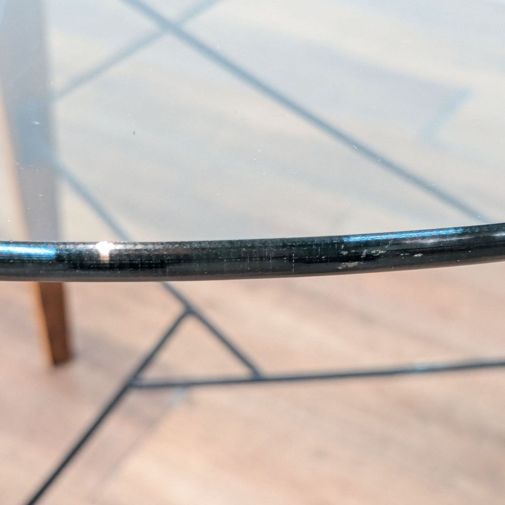 2. Close-up view of tempered glass edge and metal details from the Sapphtopaz industrial dining table.