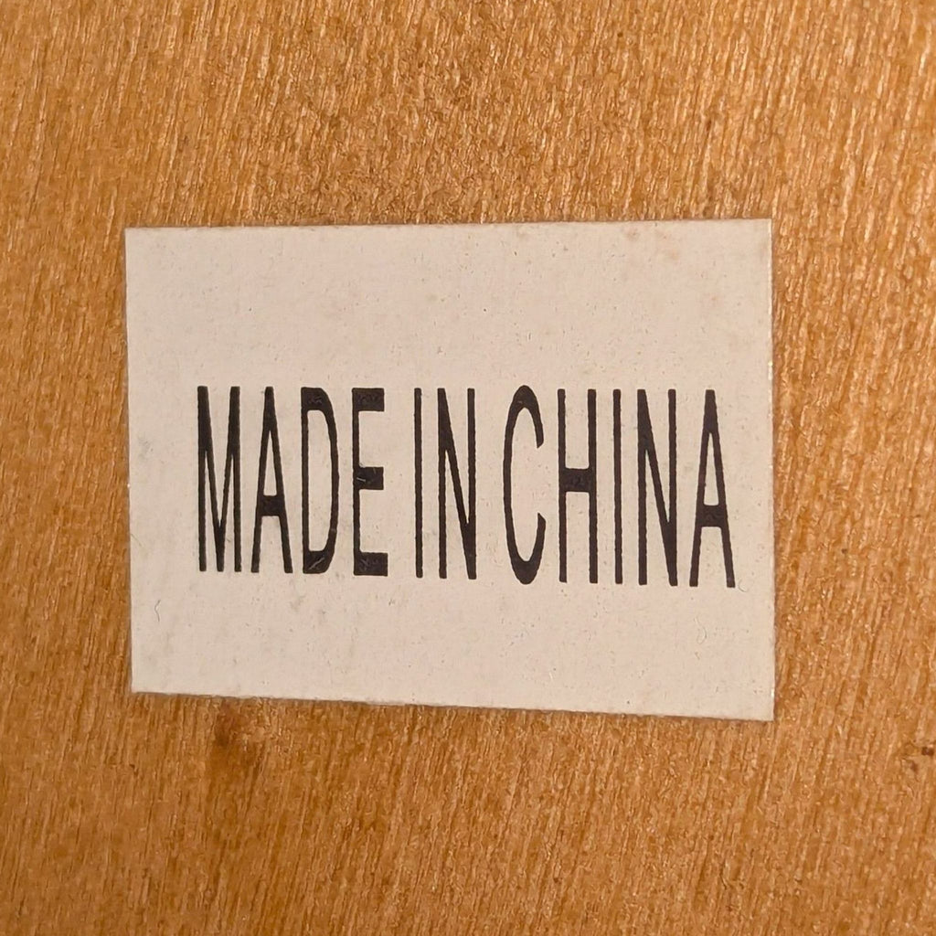 3. "MADE IN CHINA" label on wood, indicating country of origin for Sapphtopaz dining table.