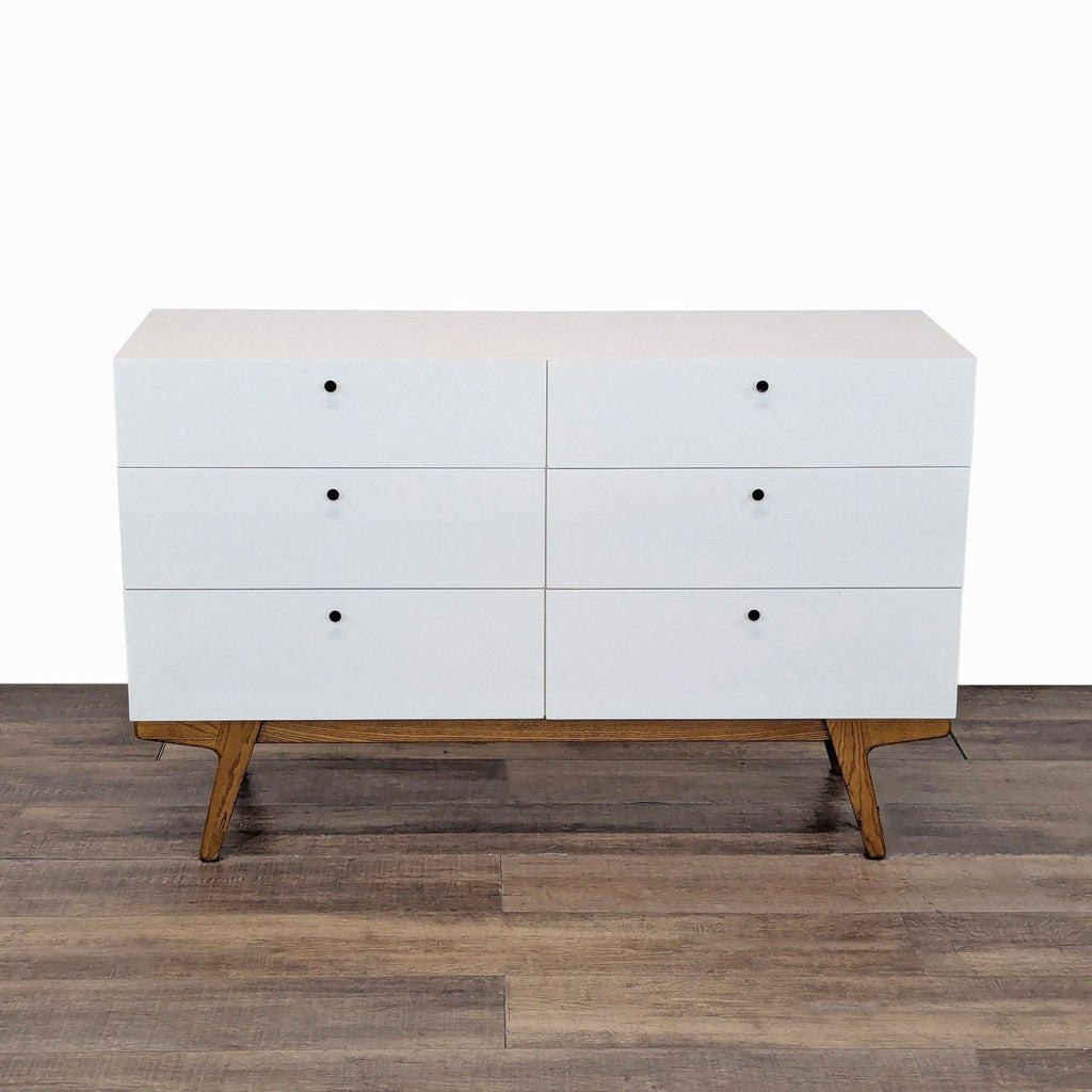 1. West Elm six-drawer dresser with a Scandinavian-inspired modern frame and angled legs, shown from the front.