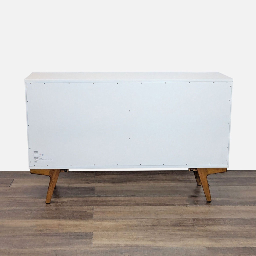3. Back view of West Elm modern dresser, highlighting clean design and angled wooden legs in Scandinavian style.