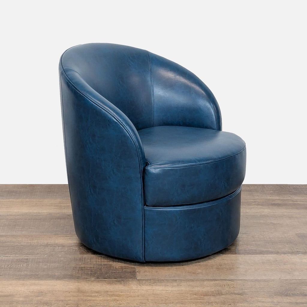 3. Angled view of Reperch Lounge barrel back chair in blue faux leather with round swivel base.