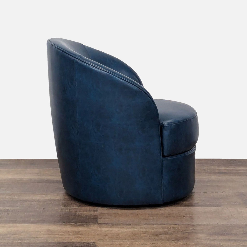 2. Side profile of Reperch Lounge blue faux leather swivel barrel chair on a wooden floor.