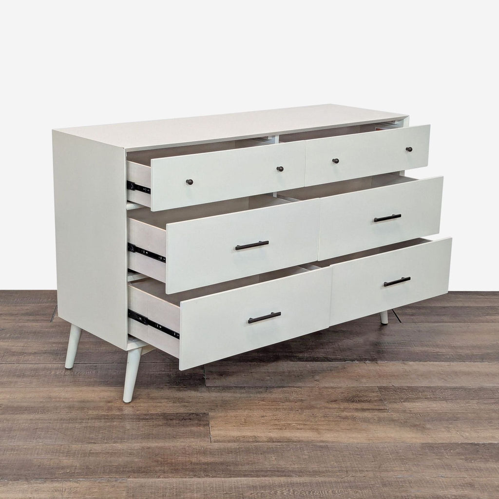 2. Side angle of Najarian Furniture's dresser showing all six drawers partially open, highlighting metal glides.