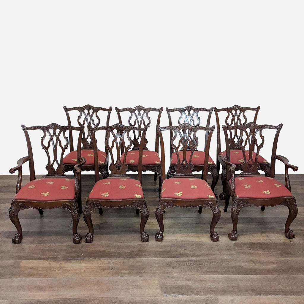 A set of English Chippendale style Henredon dining chairs with carved frames and red upholstered seats.  