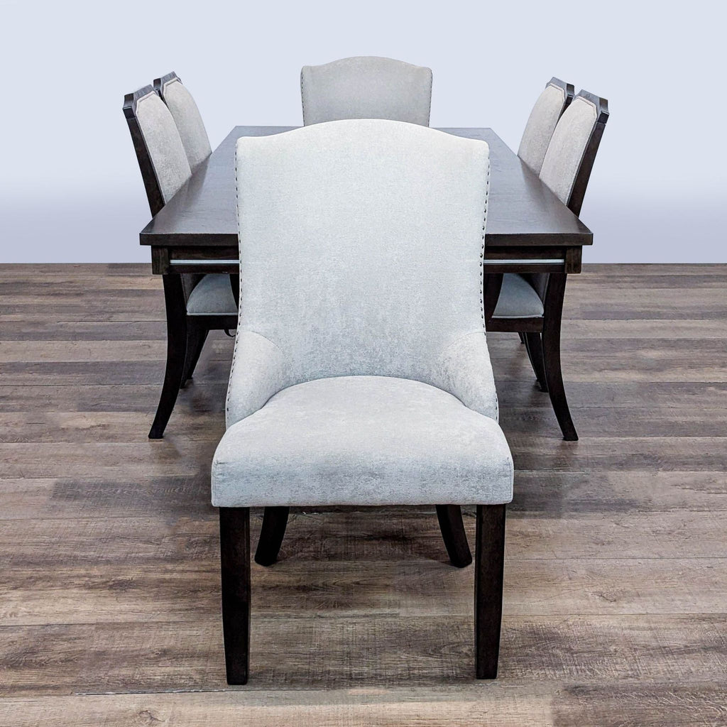 2. Front-facing view of an Ashley Furniture dining set with a rectangular table and six upholstered chairs.  