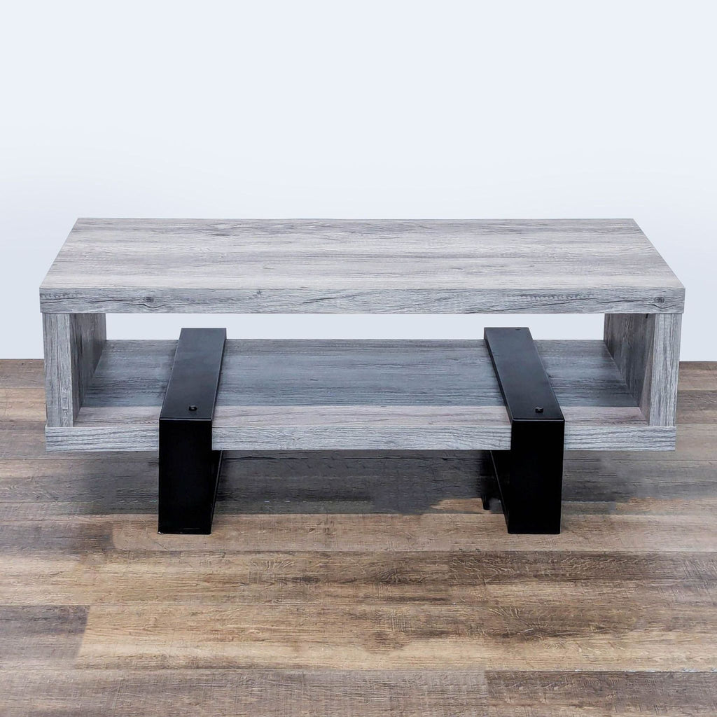 2. Modern driftwood finish coffee table by Coaster, supported by black metal legs with open shelving below.