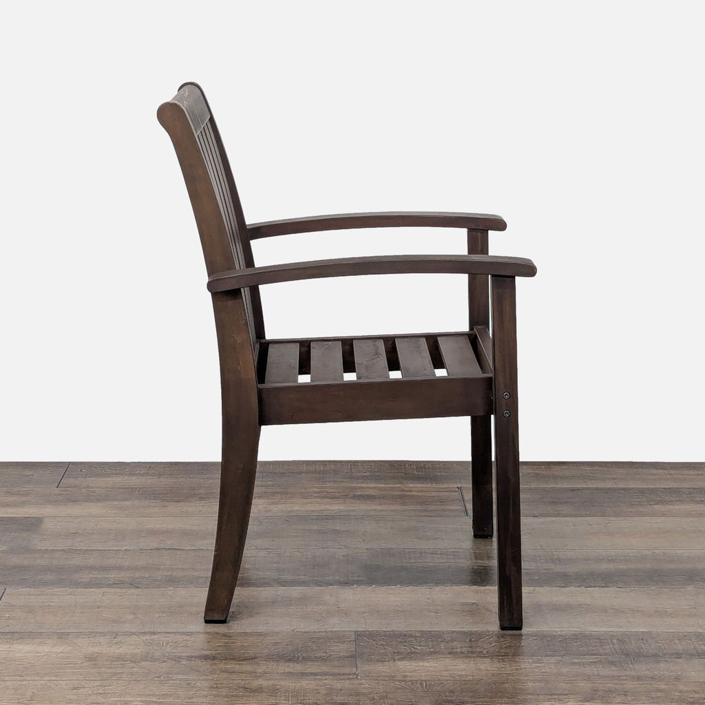 3. Side profile of the Pottery Barn Chatham wooden chair with curved arms and visible slatted seat.