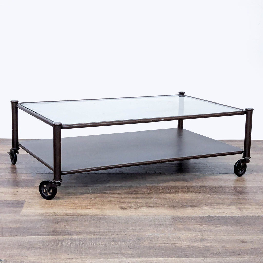 2. Industrial-style Reperch coffee table featuring a clear glass top and metal shelf, supported by wheels.