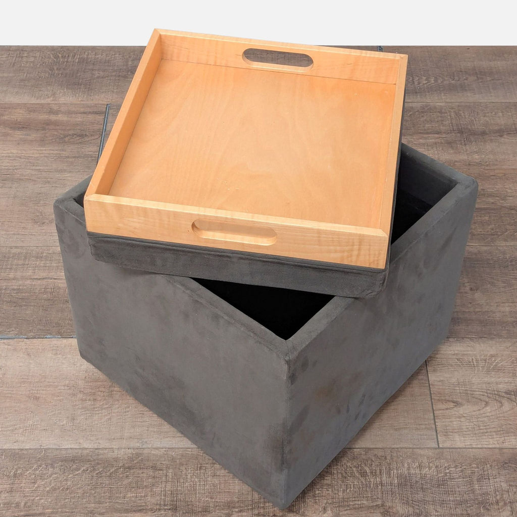 2. Multi-functional gray ottoman featuring hidden storage and a removable wooden tray, ideal for modern spaces.