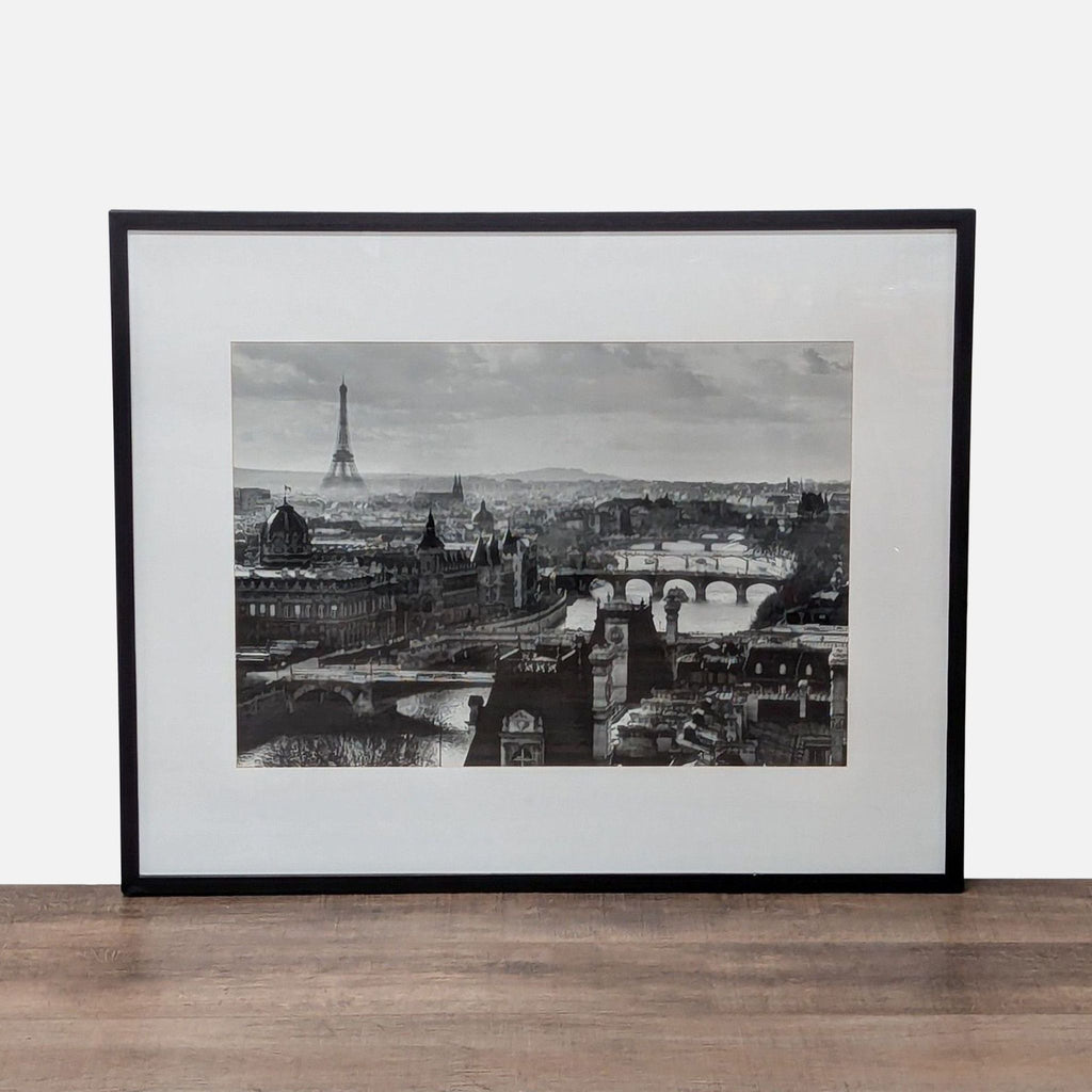 1. Framed black and white Crate and Barrel print of the River Seine in France, with the Eiffel Tower visible.