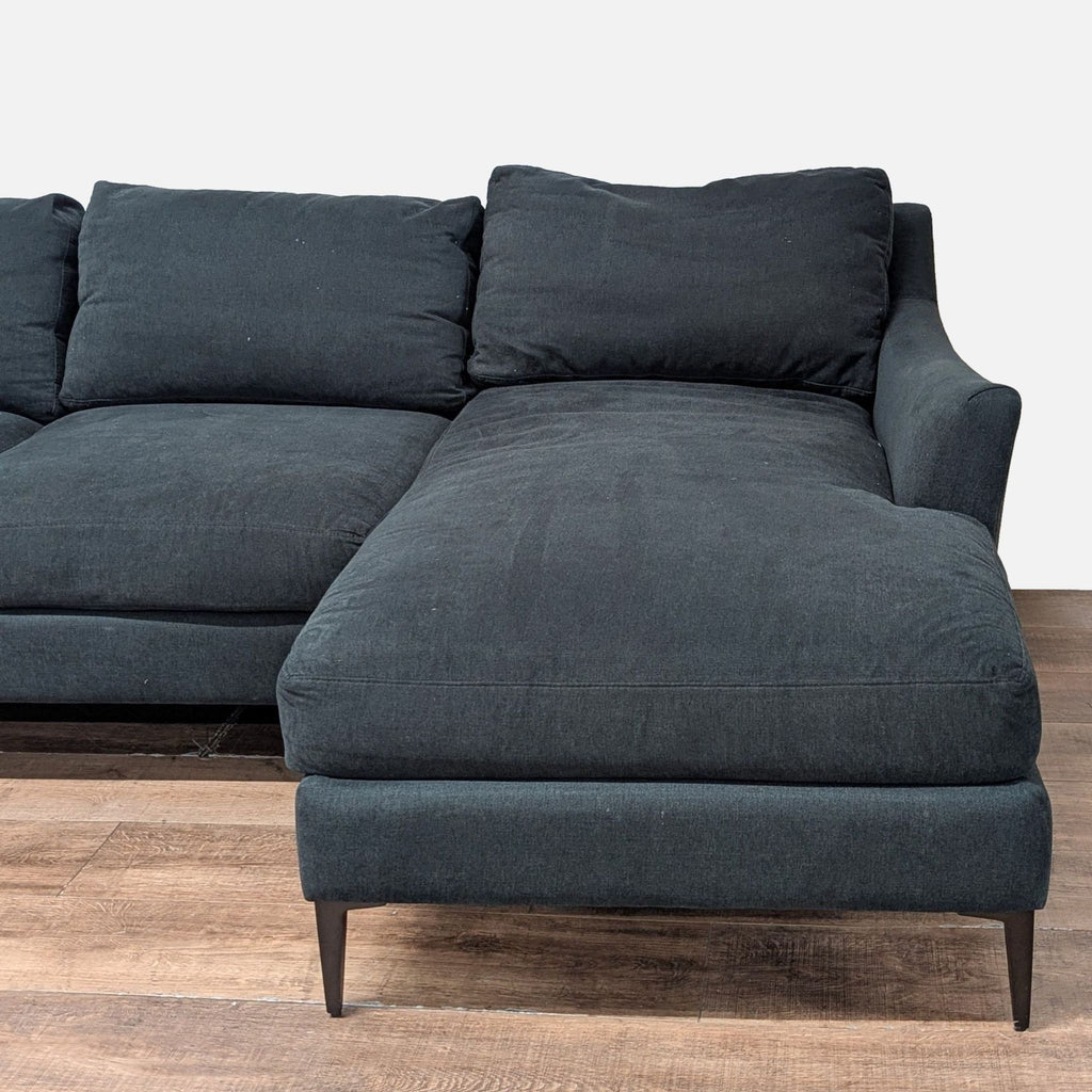 2. Close-up of the chaise section on a Jonathan Louis modular sectional, featuring fabric upholstery and metal legs.