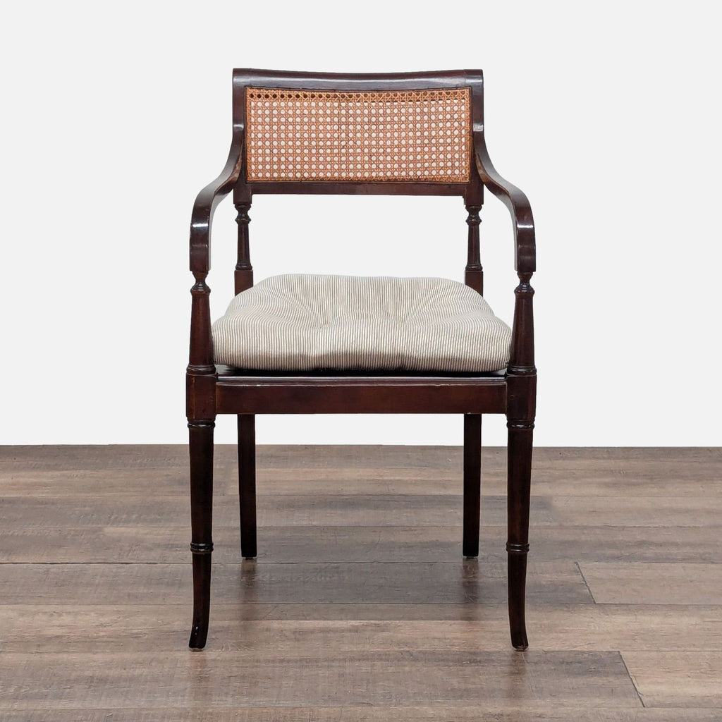 1. Mahogany wood chair with cane back, armrests, and a removable beige cushion, by Reperch.  