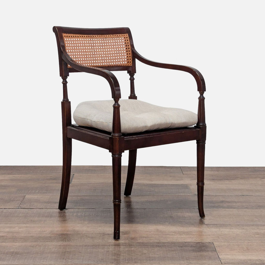 3. Angled view of Reperch chair showing mahogany frame, cane backrest, and plush removable cushion.