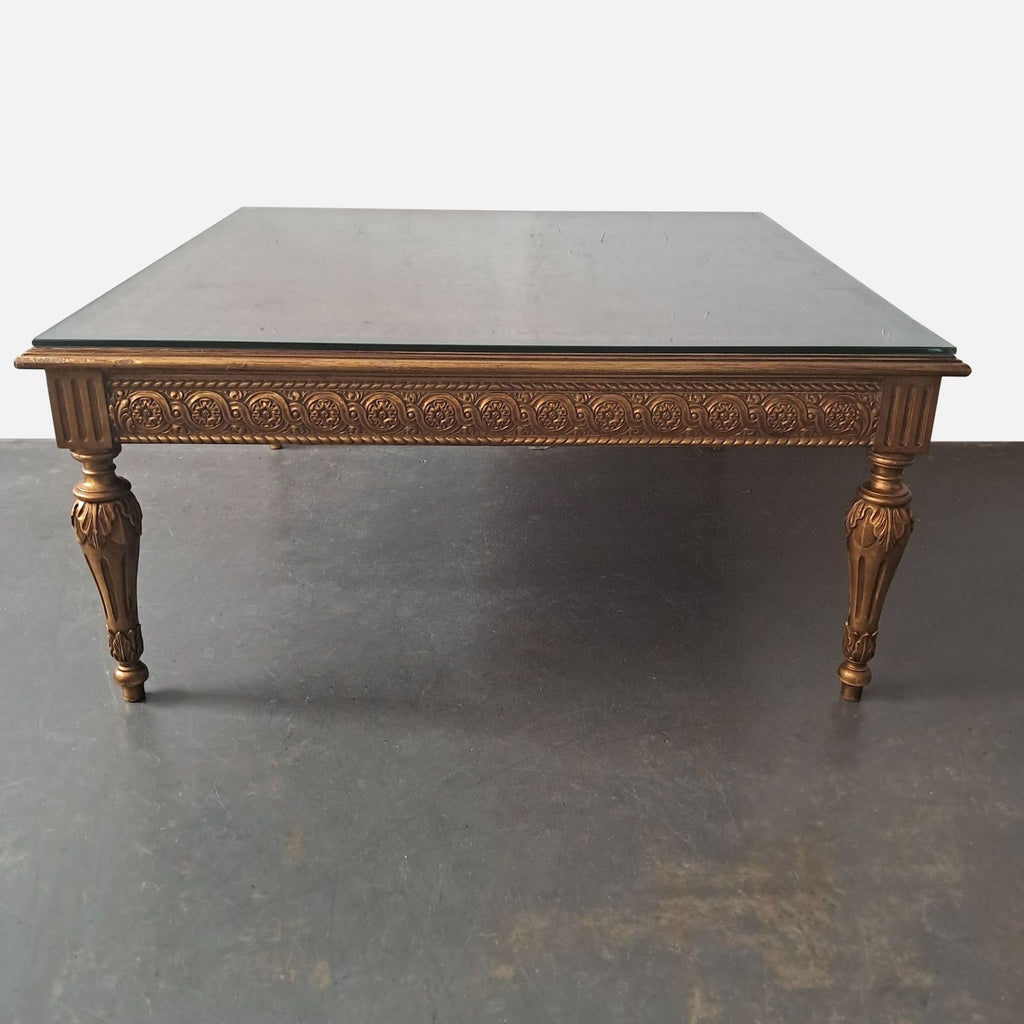 1. Reperch coffee table with gilt accents, intricate marquetry, myrtle veneers, and a custom glass top.