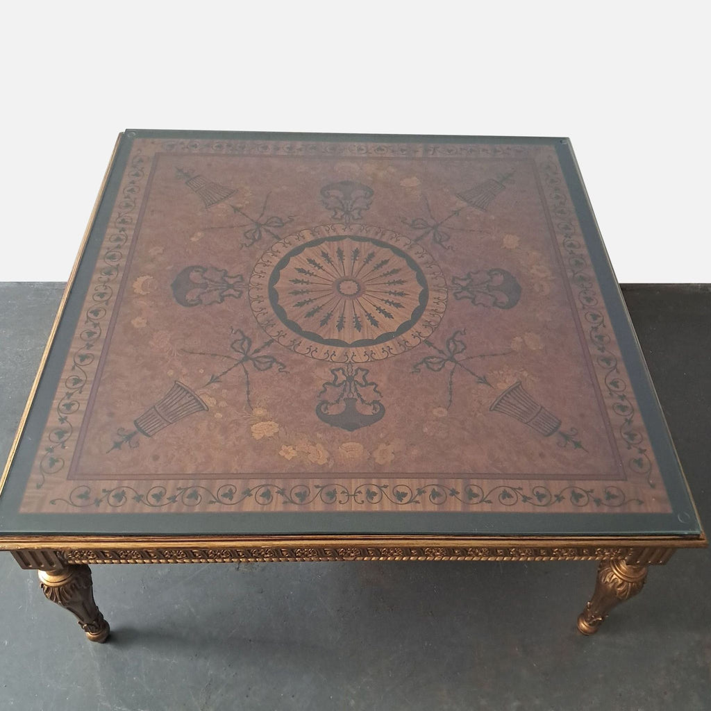 3. Overhead view of Reperch coffee table, showing detailed marquetry and decorative patterns beneath the glass top.