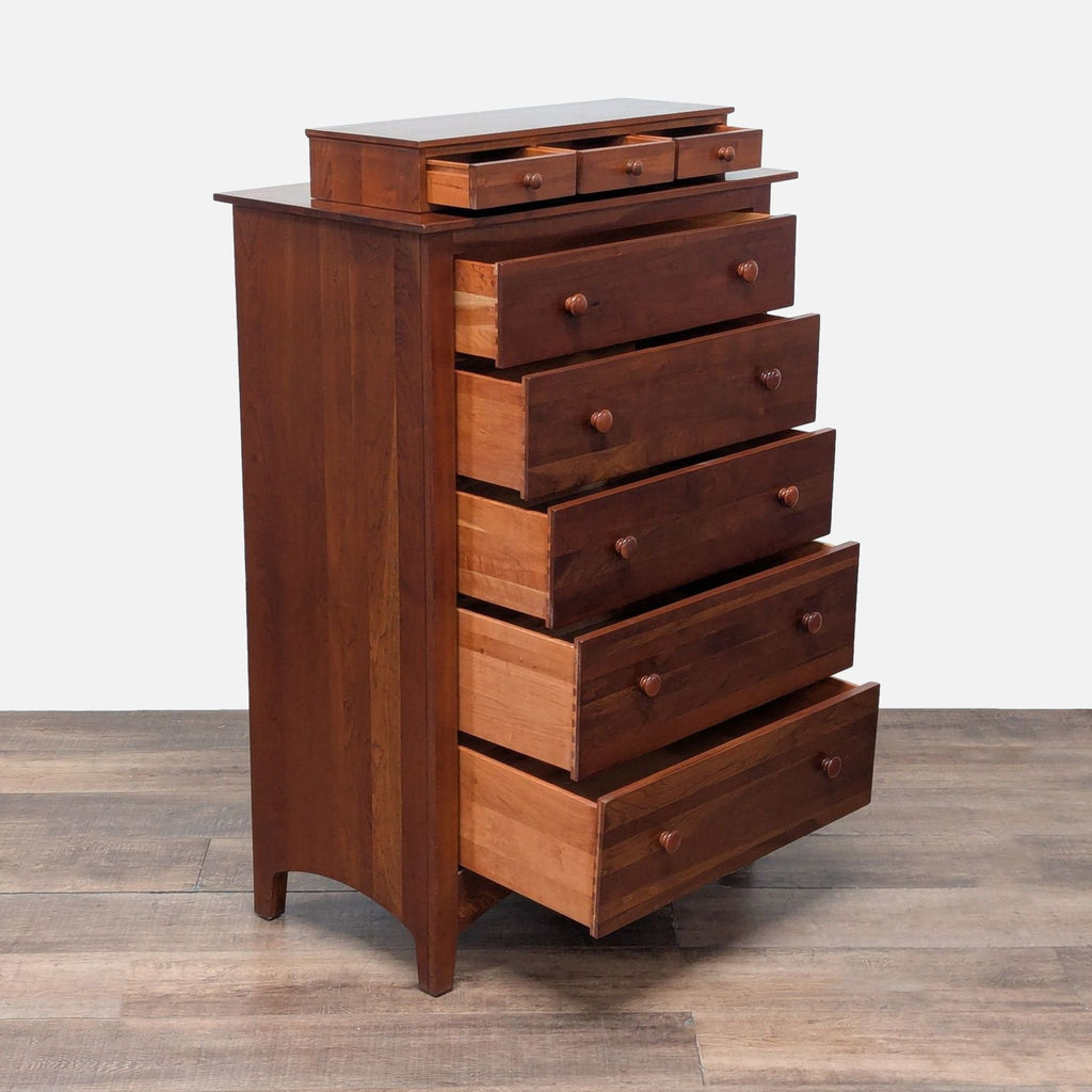 Angled view showing open drawers of the Ethan Allen cherry wood dresser with wood knobs and dovetail joinery.
