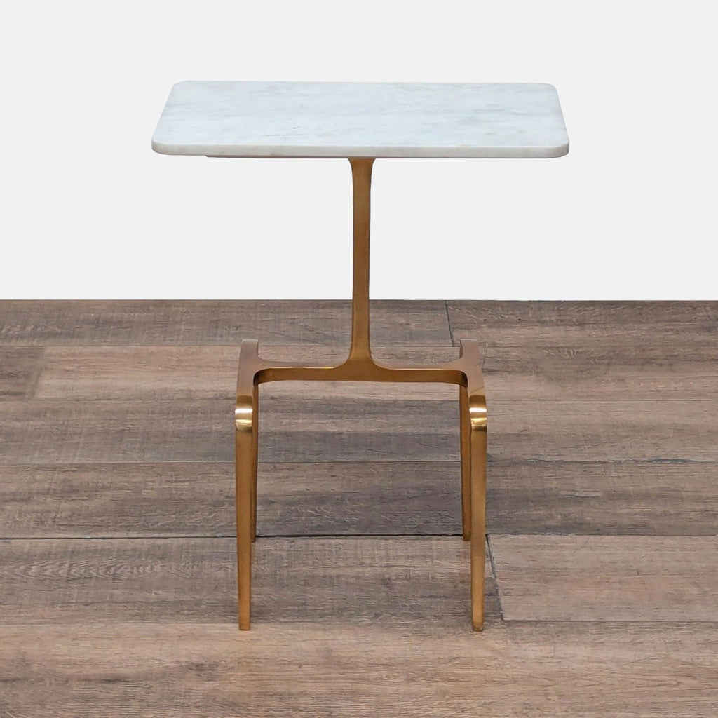 1. CB2 end table with a Banswara marble top and gold brass-finished aluminum base on wood floor.