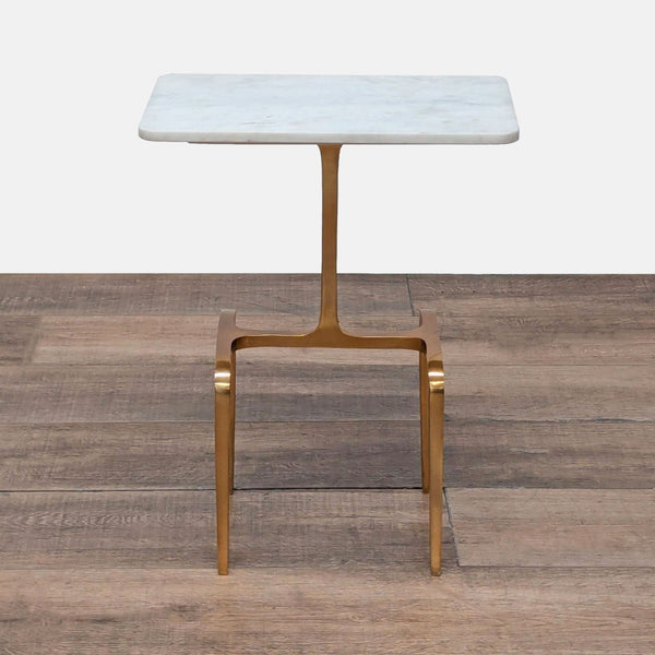 1. CB2 end table with a Banswara marble top and gold brass-finished aluminum base on wood floor.