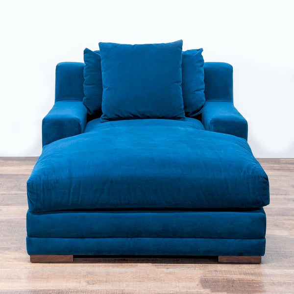 Plush blue chaise lounge with track arms, wood block feet, and removable cushions by Living Spaces.  